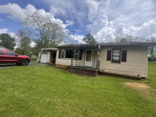 Before: ranch home with worn beige siding and a dated porch