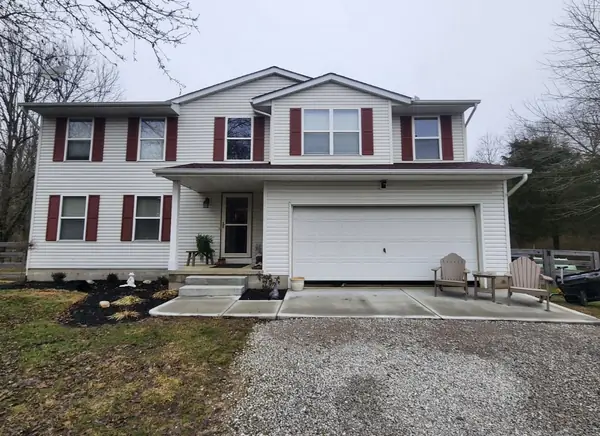 Before: two-story home with dated vinyl siding and red shutters