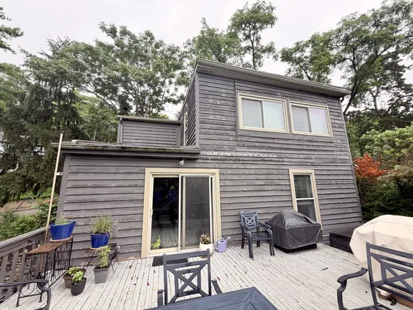 Before: contemporary home with weathered gray wood siding