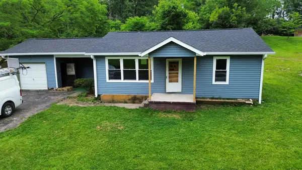 Ranch home finished with a new roof and blue siding with white trim