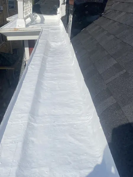 Built-in box gutter coated with a white elastomeric waterproof finish