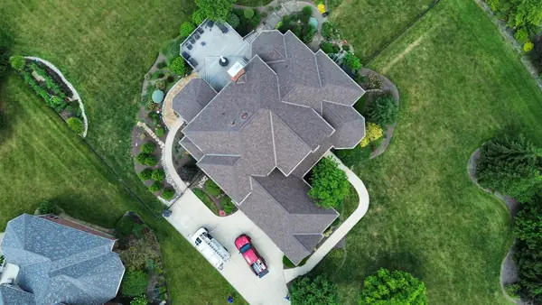 Top-down drone view of a finished roof with multiple hips and valleys