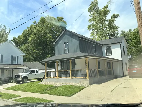Farmhouse finished in gray siding with a new wrap-around porch