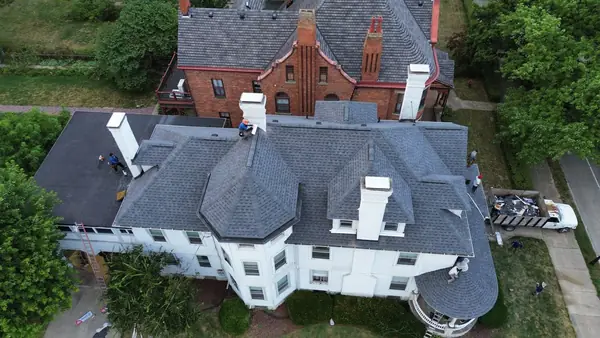 Roof replacement on a large historic home with turrets and dormers