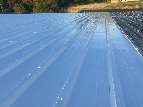 Corrugated metal roof coated with a reflective silver protective finish