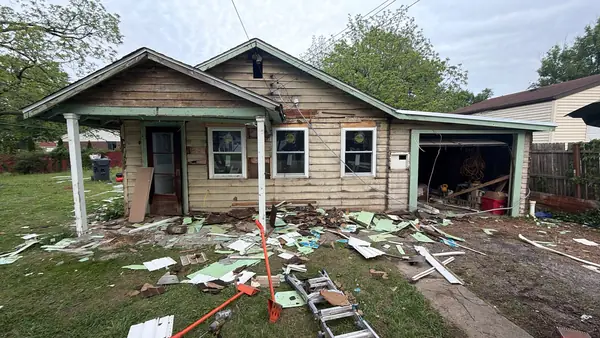 Old siding stripped from a single-story bungalow before new siding goes on