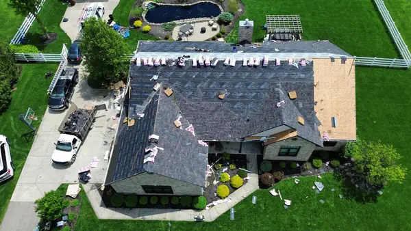 Aerial view of a full roof tear-off with new decking on a ranch home