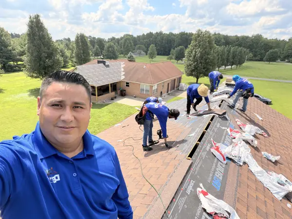 DV Dependable Roofing crew installing shingles over new underlayment