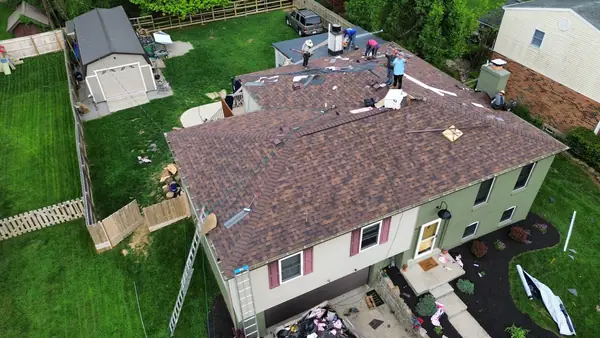 Aerial view of a split-level home roof replacement in progress
