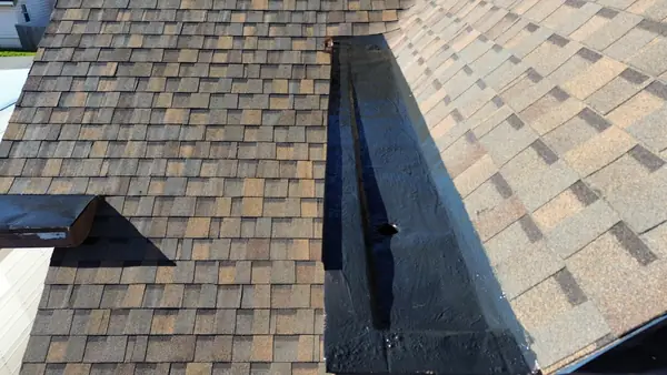 Open roof valley lined with ice and water shield between shingle planes