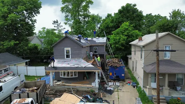 Aerial view of a whole-home exterior renovation with roof and porch work
